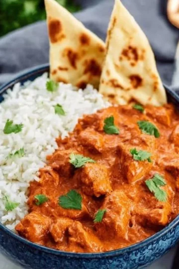 Delicious homemade butter chicken served with rice and naan