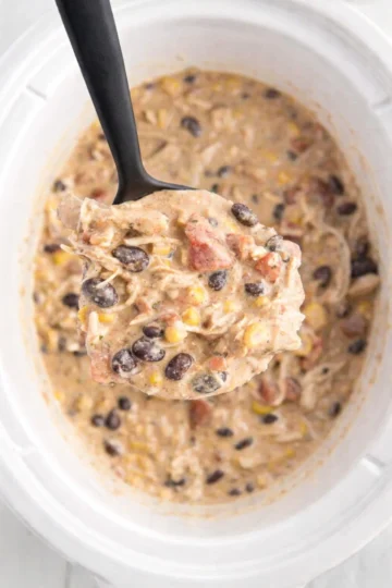 Bowl of delicious Crockpot White Chicken Chili garnished with herbs