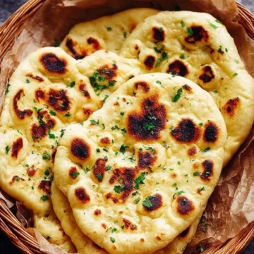 Homemade naan bread fresh out of the oven, golden and fluffy
