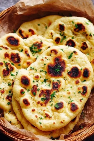 Homemade naan bread fresh out of the oven, golden and fluffy