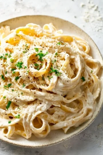 Delicious plate of Fettuccine Alfredo garnished with parsley