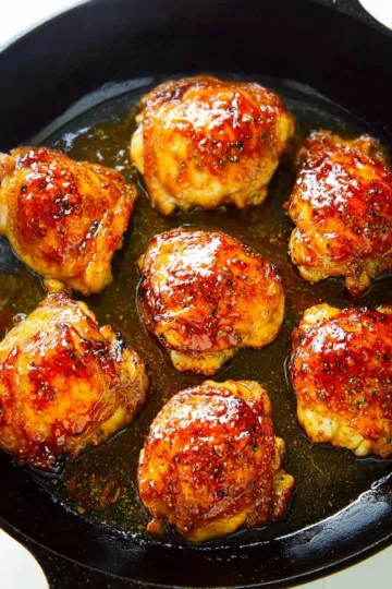 Honey Garlic Chicken Thighs served on a plate with parsley garnish