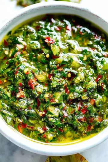 Bowl of authentic chimichurri sauce with fresh herbs and spices