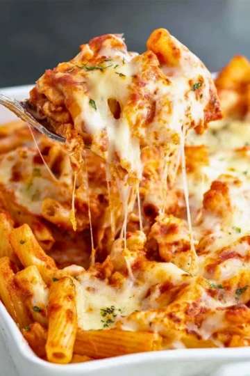 Delicious baked ziti with cheese and marinara sauce in a baking dish