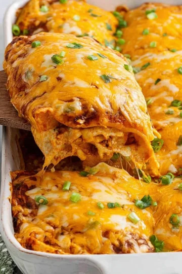 Delicious Chicken Enchilada Casserole topped with melted cheese and fresh herbs