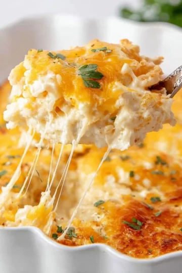 Delicious Cracker Barrel hash brown casserole topped with cheese and baked to perfection.