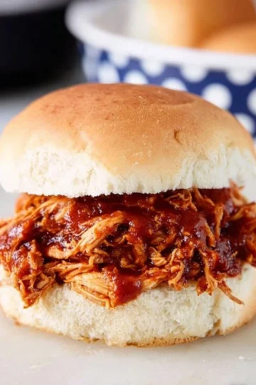 Delicious crockpot BBQ chicken served on a plate with sides