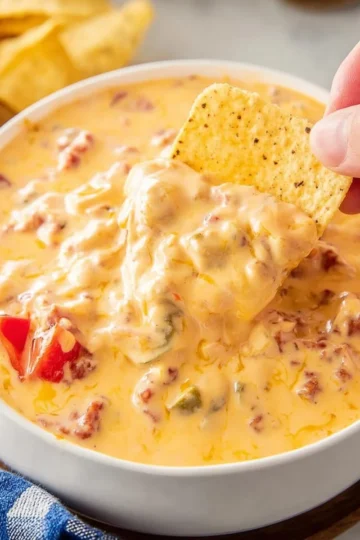 Creamy Crockpot Rotel Dip with melted cheese and diced tomatoes