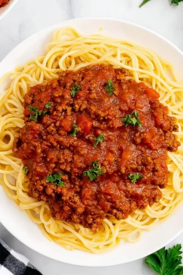 Bowl of easy homemade spaghetti sauce with fresh herbs and tomatoes