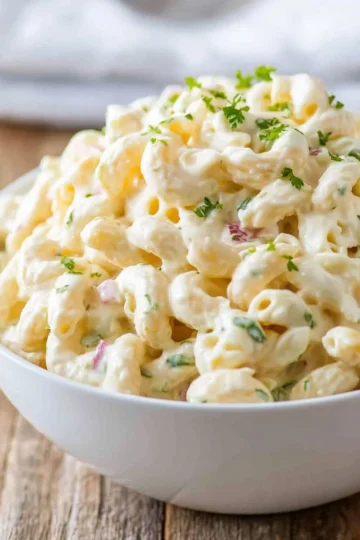 Bowl of easy macaroni salad with colorful vegetables and creamy dressing