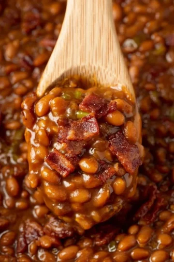 Bowl of Easy Ultimate Baked Beans garnished with herbs