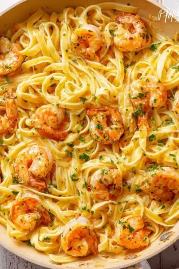 Delicious Garlic Butter Shrimp Pasta topped with fresh parsley and served in a bowl.