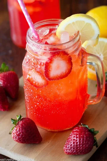 Glass of homemade strawberry lemonade with fresh strawberries and lemon slices