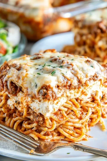 Delicious Million Dollar Spaghetti topped with rich sauce and melted cheese