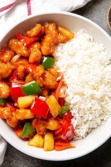 Delicious plate of homemade Sweet and Sour Chicken with vibrant colors