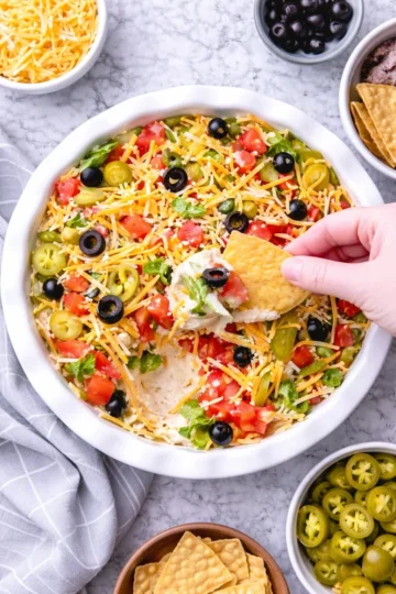 Delicious Taco Dip served in a colorful dish with fresh toppings