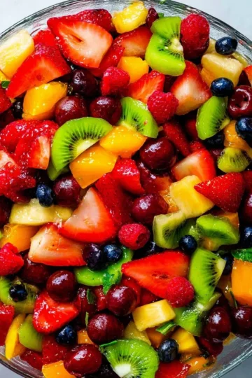 A colorful bowl of the very best fruit salad with a variety of fresh fruits.
